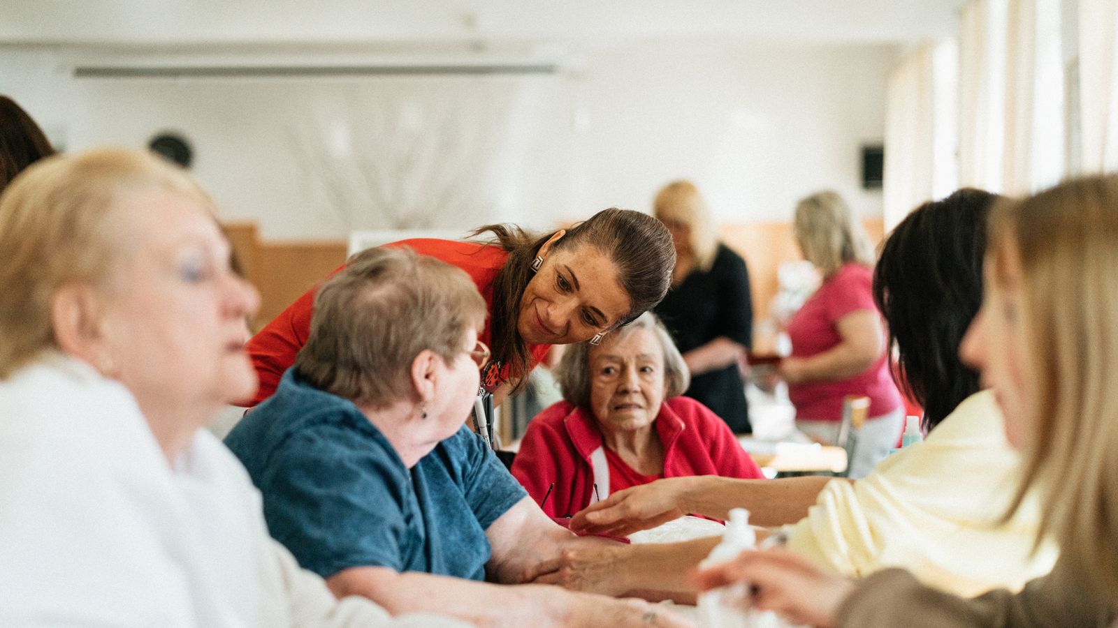 Staff and residents talking around a table